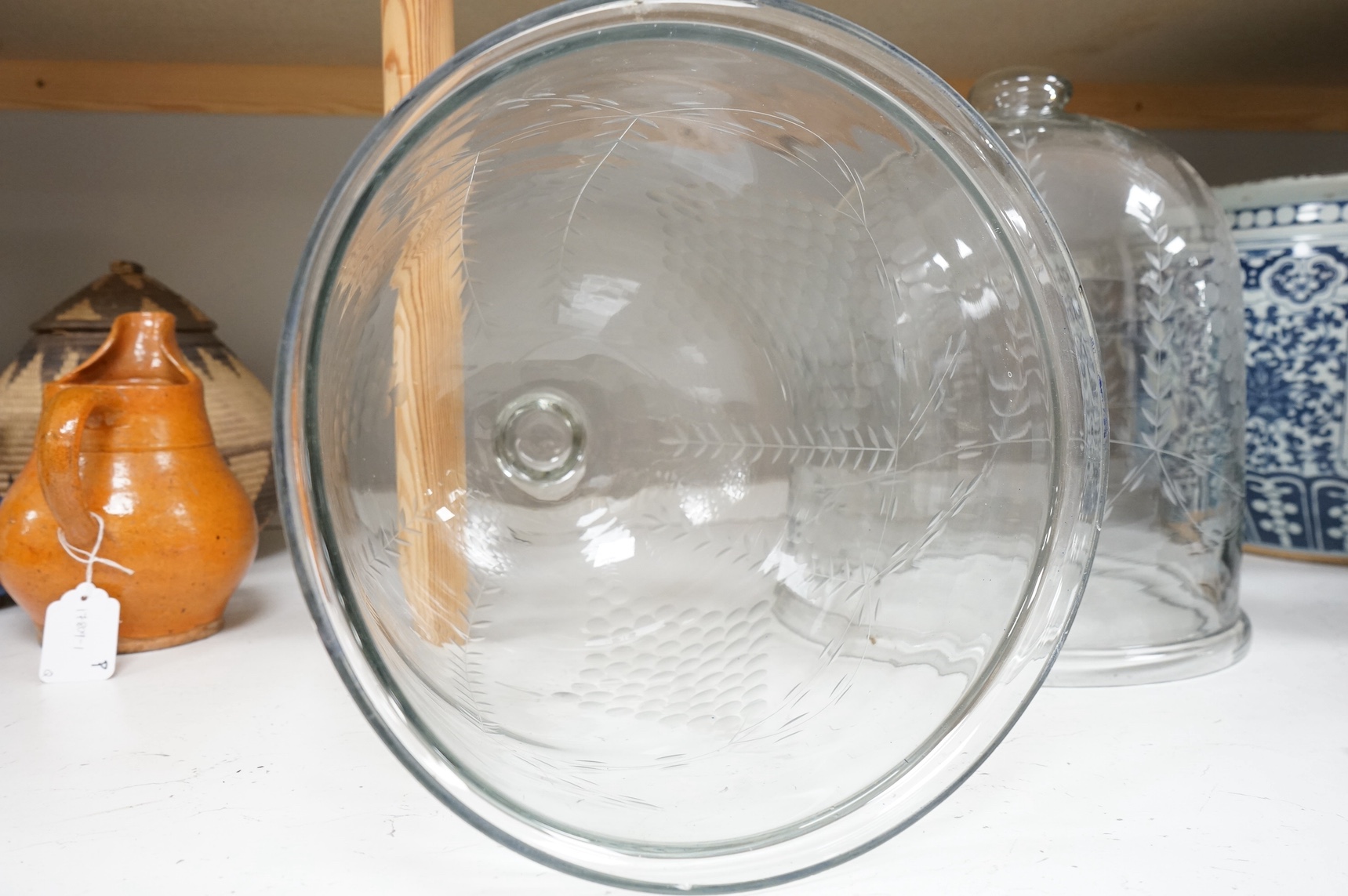 A pair of continental glass engraved cheese domes, 37cm high. Condition - good